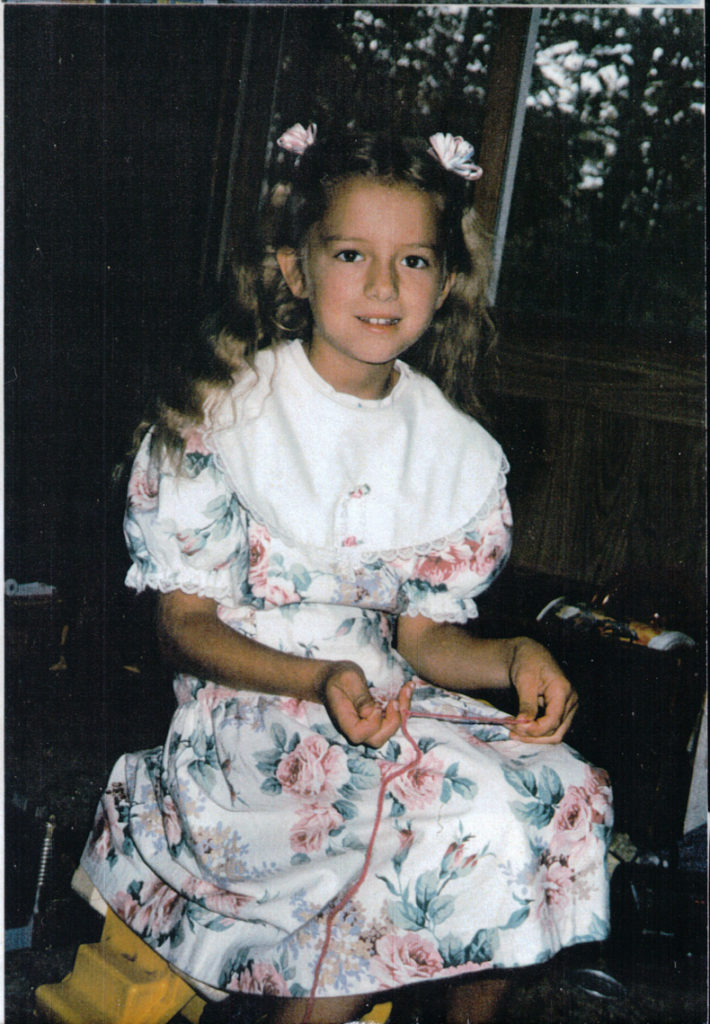 girl knits in dress