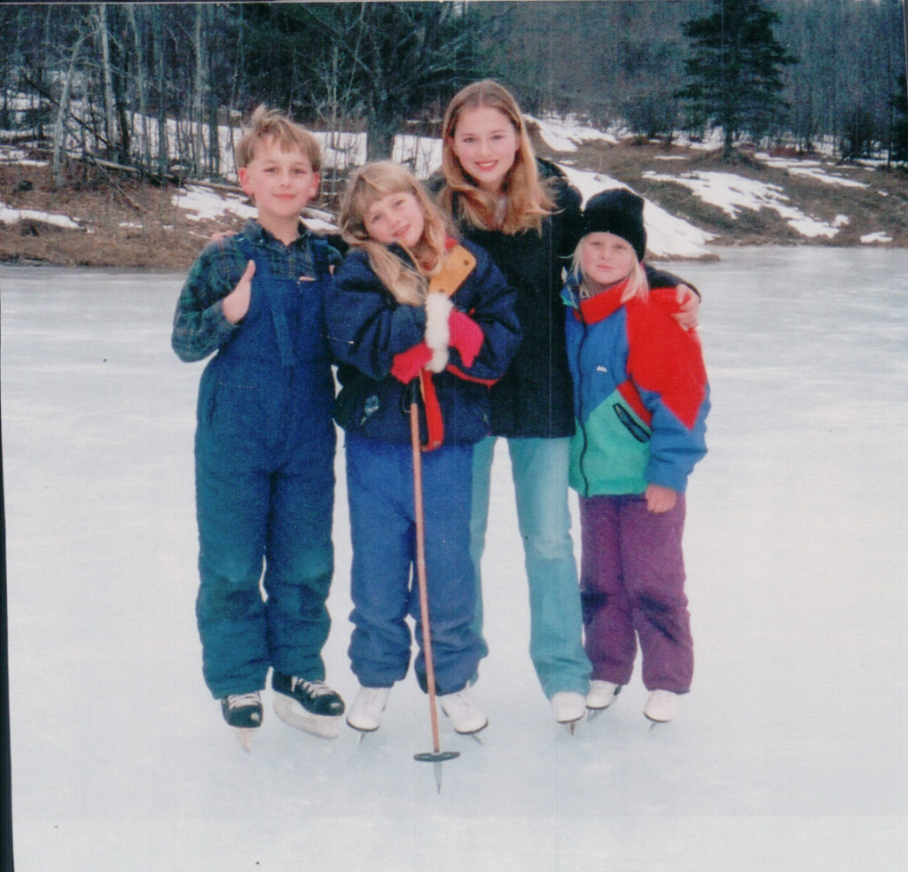 four children ice skating in Maine