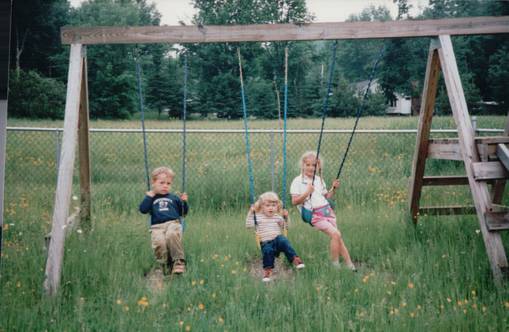 3 children on swingset
