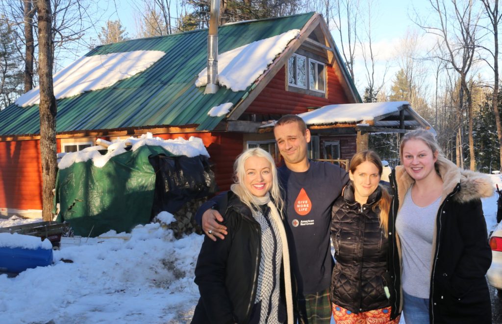 4 sibling in front of cabin in rural maine