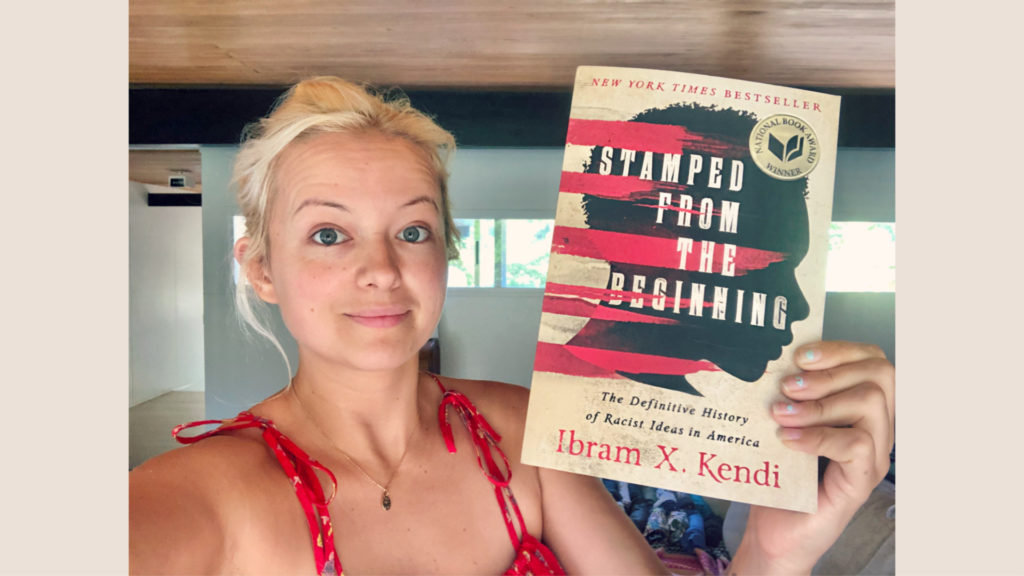 Anna Kate Holding Ibram X. Kendi's book Stamped from the Beginning: The Definitive History of Racist Ideas in America